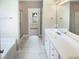Bathroom with white cabinets, a large mirror, and a shower with glass doors at 182 Inverness St, Zebulon, NC 27597