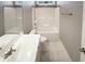 Bright bathroom featuring a white vanity, toilet, and shower-tub combo at 182 Inverness St, Zebulon, NC 27597