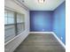 A clean and bright room with wood floors and a large window offering plenty of natural light at 182 Inverness St, Zebulon, NC 27597