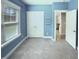 Carpeted bedroom with closet and shelving; next to a brightly lit kitchen and pantry area at 182 Inverness St, Zebulon, NC 27597