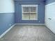 A cozy bedroom featuring plush carpet, a window, and ample closet space at 182 Inverness St, Zebulon, NC 27597