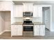 Stainless steel appliances and white cabinets in an inviting kitchen at 182 Inverness St, Zebulon, NC 27597