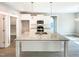 Open kitchen with a large granite island with a sink and stainless appliances at 182 Inverness St, Zebulon, NC 27597