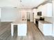 Spacious kitchen with granite countertops, a kitchen island, and vinyl floors at 182 Inverness St, Zebulon, NC 27597