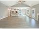 Open-concept living space featuring a kitchen, fireplace, and vinyl plank flooring at 182 Inverness St, Zebulon, NC 27597