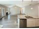 Open living area with a kitchen island, fireplace, and vinyl plank flooring at 182 Inverness St, Zebulon, NC 27597