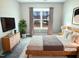 Cozy bedroom with a wooden bed frame, soft bedding, and a large window at 182 Inverness St, Zebulon, NC 27597