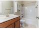 Bathroom featuring a shower-tub combo, storage cabinet, and cherry vanity at 1922 Pattersons Mill Rd, Durham, NC 27703