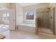 Bright bathroom featuring tiled shower, bathtub, and tile floors at 1922 Pattersons Mill Rd, Durham, NC 27703