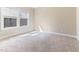 Bedroom with a neutral color scheme and natural light streaming through the window at 1922 Pattersons Mill Rd, Durham, NC 27703