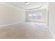 Spacious bedroom with tray ceiling, carpet, and multiple windows at 1922 Pattersons Mill Rd, Durham, NC 27703