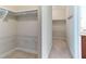 Walk-in closet with white shelving and beige carpeting at 1922 Pattersons Mill Rd, Durham, NC 27703
