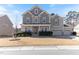 Inviting two-story home with a manicured lawn and a three-car garage, offering curb appeal and ample parking at 1922 Pattersons Mill Rd, Durham, NC 27703