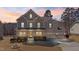 Striking two-story home at sunset with a well-maintained lawn and a three-car garage, exuding warmth at 1922 Pattersons Mill Rd, Durham, NC 27703
