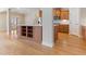 Kitchen island featuring cabinets, stainless refrigerator, and hardwood floors at 1922 Pattersons Mill Rd, Durham, NC 27703
