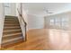 Bright living room with hardwood floors and staircase, offering a welcoming and spacious area at 1922 Pattersons Mill Rd, Durham, NC 27703
