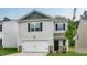 Home with white siding, black shutters, with a two-car garage, and manicured lawn at 194 Oak Barrel Rd, Smithfield, NC 27577