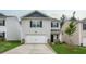 Home with gray siding, black shutters, with a two-car garage, and manicured lawn at 194 Oak Barrel Rd, Smithfield, NC 27577