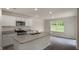 Kitchen with island featuring white cabinets, granite counters, and stainless steel appliances at 194 Oak Barrel Rd, Smithfield, NC 27577