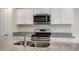 Kitchen featuring white cabinets, stainless steel appliances, and granite countertops at 194 Oak Barrel Rd, Smithfield, NC 27577