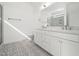 Bright bathroom with double vanity, patterned tile floor, and modern fixtures at 20 Wildflower Ln, Franklinton, NC 27525
