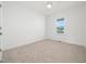 Bright bedroom with neutral carpet, white walls, and a large window at 20 Wildflower Ln, Franklinton, NC 27525