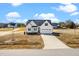 Charming two-story home featuring a long driveway, attached two-car garage, and landscaped yard at 20 Wildflower Ln, Franklinton, NC 27525