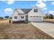Charming single-Gathering home featuring a two-car garage and manicured lawn at 20 Wildflower Ln, Franklinton, NC 27525