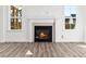 Close up of fireplace featuring a decorative mantle and tile surround between large windows at 20 Wildflower Ln, Franklinton, NC 27525