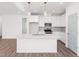 Kitchen with large island, modern light fixtures, stainless appliances, and all white cabinets at 20 Wildflower Ln, Franklinton, NC 27525