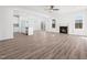 Bright and open living room with fireplace, wood flooring, and an abundance of natural light at 20 Wildflower Ln, Franklinton, NC 27525