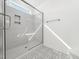 Modern tiled walk-in shower with gray accents and glass doors and walls at 20 Wildflower Ln, Franklinton, NC 27525