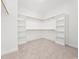 Large walk-in closet with carpet floors and shelving and wooden rods for storage at 20 Wildflower Ln, Franklinton, NC 27525