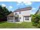 View of a backyard with a screened porch, a patio area, and lush landscaping at 2017 Ollivander Dr, Cary, NC 27519