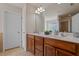 Bathroom with double sink vanity, tile flooring and glass block window for privacy at 2017 Ollivander Dr, Cary, NC 27519
