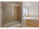 Bathroom with a glass shower and soaking tub at 2017 Ollivander Dr, Cary, NC 27519