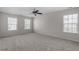 Spacious carpeted bedroom with lots of natural light from the windows at 2017 Ollivander Dr, Cary, NC 27519