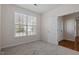 Neutral bedroom with carpet flooring, and natural light from the window with white blinds at 2017 Ollivander Dr, Cary, NC 27519