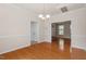 Open dining room featuring hardwood floors, decorative molding, and neutral paint; the dining area is bright and airy at 2017 Ollivander Dr, Cary, NC 27519