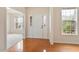 Bright entryway features hardwood floors, a large window, and a white front door with sidelights at 2017 Ollivander Dr, Cary, NC 27519