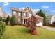 Charming two-story brick home featuring a well-manicured lawn and attached two car garage at 2017 Ollivander Dr, Cary, NC 27519