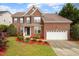 Charming two-story brick home featuring a well-manicured lawn and attached two car garage at 2017 Ollivander Dr, Cary, NC 27519
