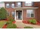 Charming entryway with a dark front door, white columns, and landscaped garden at 2017 Ollivander Dr, Cary, NC 27519