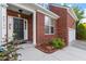 Close-up of a brick home's front entrance with manicured landscaping and a two-car garage at 2017 Ollivander Dr, Cary, NC 27519