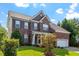 Beautiful brick home with a well-maintained lawn and two-car garage at 2017 Ollivander Dr, Cary, NC 27519