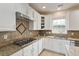 Bright kitchen featuring granite countertops, stainless steel appliances, and white cabinets at 2017 Ollivander Dr, Cary, NC 27519