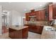 Spacious kitchen featuring an island with granite countertops, stainless steel appliances and tile floors at 2017 Ollivander Dr, Cary, NC 27519