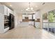 Spacious eat-in kitchen with white cabinets, stainless steel appliances, and sliding glass doors to the backyard at 2017 Ollivander Dr, Cary, NC 27519