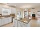 Modern kitchen featuring granite countertops, stainless steel appliances, and white cabinets at 2017 Ollivander Dr, Cary, NC 27519