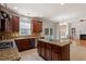 Well-appointed kitchen with stainless steel appliances, granite counters, tile backsplash, island and views to the living room at 2017 Ollivander Dr, Cary, NC 27519